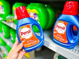 Persil laundry detergent (20-load 34 oz bottle) held up in laundry aisle at Walmart