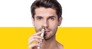 A man using a Conair nose hair trimmer