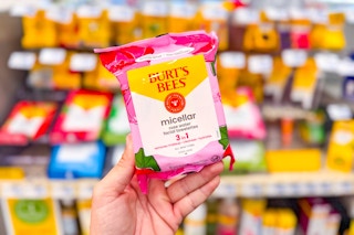 person holding a package of burts bees micellar wipes