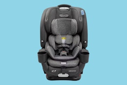 A Graco 5-in-1 car seat on a blue background. 
