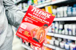 person holding a package of tylenol pain relief patches