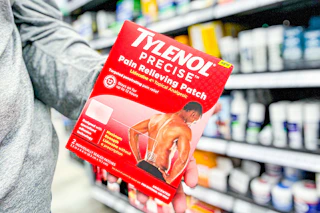 person holding a package of tylenol pain relief patches