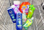 nivea body wash, lysol wipes, tide pods, softsoap hand soap, and garnier shampoo in a cart