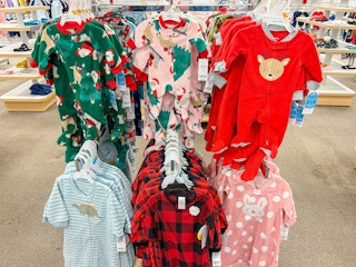 carter's christmas jammies hanging on a rack
