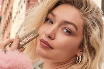 a model holding maybelline super fluff