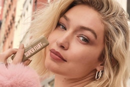 a model holding maybelline super fluff