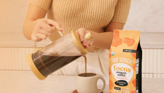 a person pouring coffee in a cup