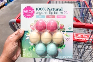 eos organic lip balm seven pack handheld at costco in front of a shopping cart