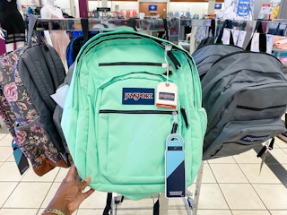 a bright green jansport backpack on display