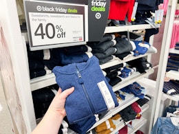 hand holding a toddler sweatshirt in front of target signage