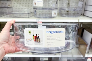 hand holding a brightroom turntable in front of storage at target