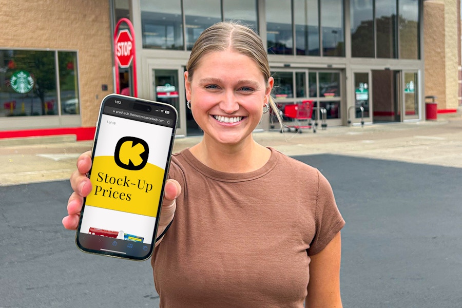 someone holding up their phone showing the KCL Stock Up Prices list in front of Target