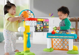 two kids playing toddler with a basketball goal and games toy set