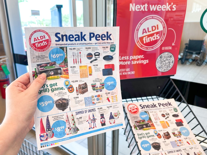 Someone holding up the Sneak Peek ad for ALDI finds