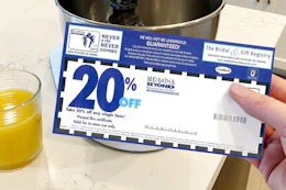 someone holding a bed bath & beyond coupon
