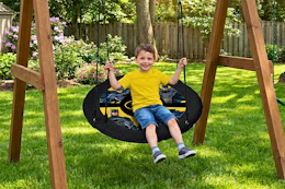 Lifestyle image of small child on Batman Saucer Swing outdoors