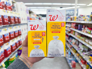 hand holding walgreens trash bag packs in store