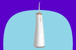 Cordless Electric Water Dental Flosser on a blue background.