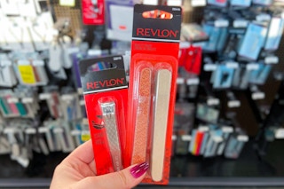 hand holding pack of Revlon nail emery boards and nail clipper