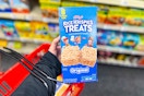 person holding a box of rice krispies treats with a cvs basket on their arm