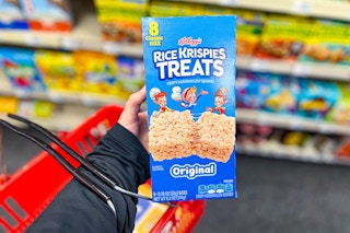 person holding a box of rice krispies treats with a cvs basket on their arm