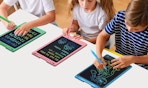 kids writing on colorful writing tablets on a table 