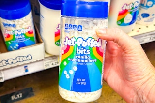 hand holding a bottle of jet puffed marshmallow bits