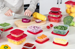 lifestyle image of a person prepping food and putting it into containers