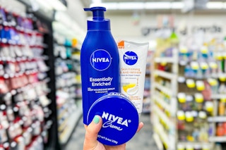 hand holding three nivea lotions creams in a store aisle