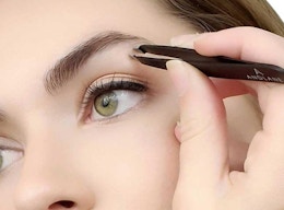 a person tweezing their eyebrows