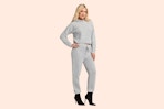 Model wearing the gray Jessica Simpson Sweater Outfit Set (complete with a sweater and matching pair of joggers)