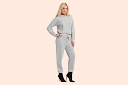 Model wearing the gray Jessica Simpson Sweater Outfit Set (complete with a sweater and matching pair of joggers)