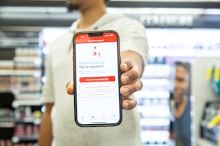 Hand holding phone that shows the CVS Pharmacy account creation page