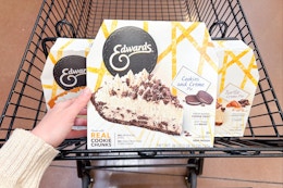 hand holding an edwards pie over shopping cart