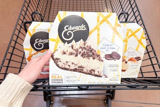 hand holding an edwards pie over shopping cart