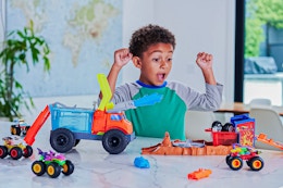 Lifestyle image of child playing with the Hot Wheels Monster Trucks Arena Playset 