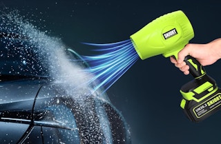 a hand holding a green cordless leaf blower