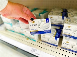hand holding a pack of dove bar soap in front of target shelf
