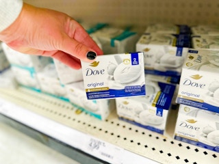 hand holding a pack of dove bar soap in front of target shelf