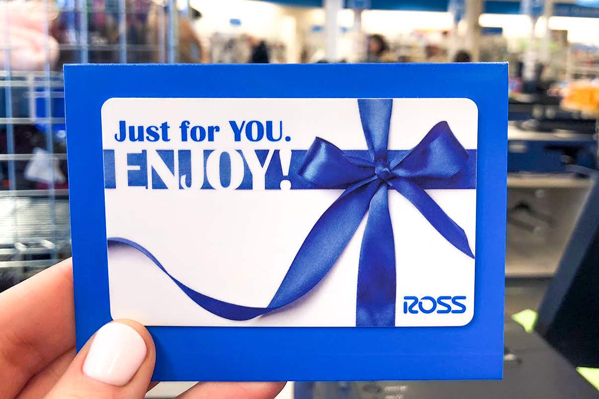 someone holding up a ross gift card