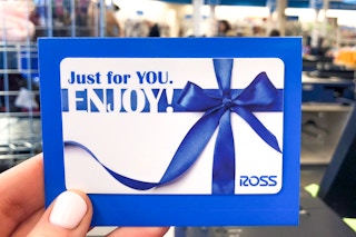 someone holding up a ross gift card