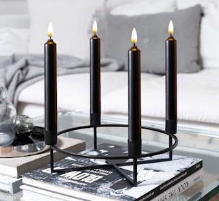 black candles in a candle holder on a table