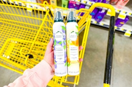 hand holding herbal essences styling products