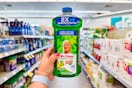 person holding a bottle of mr clean all purpose cleaner in an aisle
