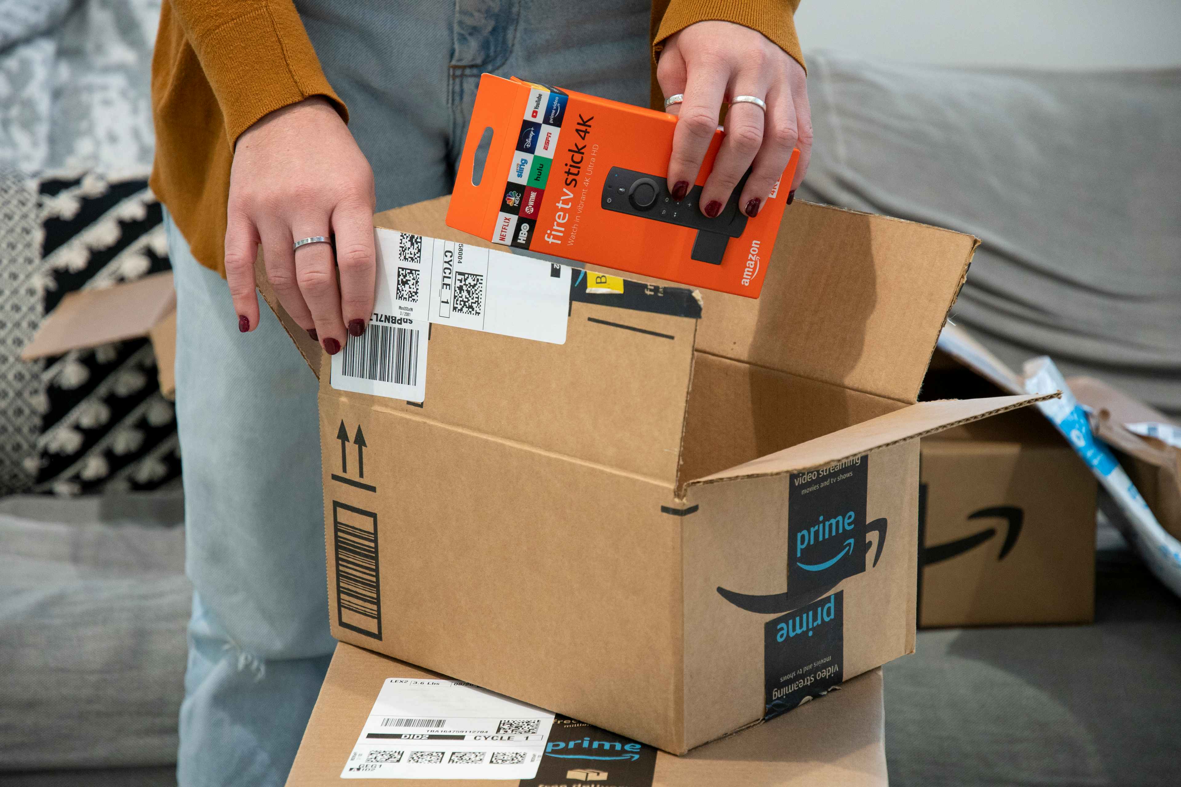woman removing Fire TV Stick 4K from Amazon box
