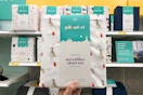 hand holding up pillowfort sheets at target