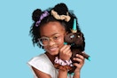 Lifestyle image of a girl holding a Plush Unicorn Doll with hair scrunchies 