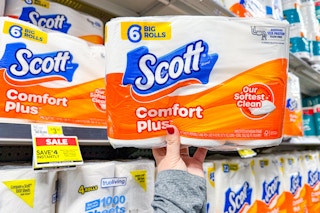 hand holding pack of scott toilet paper at dollar general