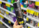 hand holding one tresemme hair spray can