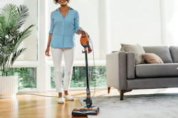 a woman using a shark vacuum